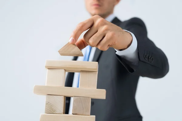 Businessman building tower — Stock Photo, Image