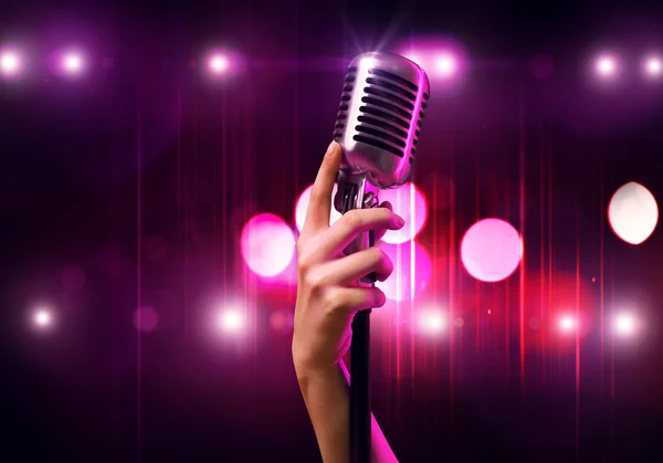 Female hand  holding microphone — Stock Photo, Image