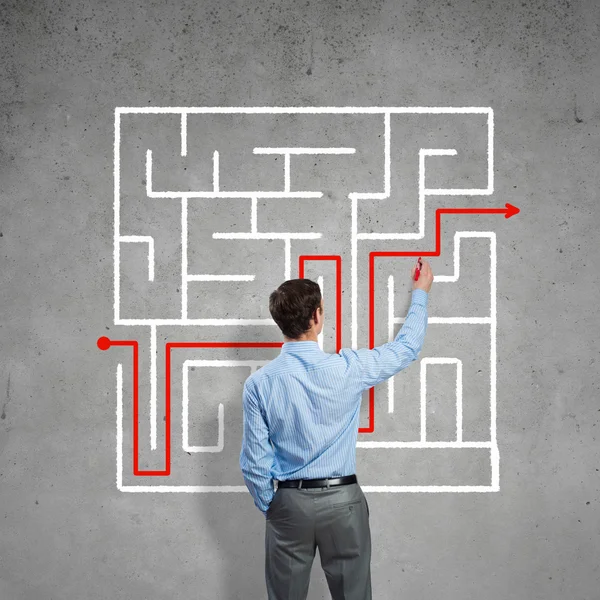 Businessman drawing labyrinth — Stock Photo, Image