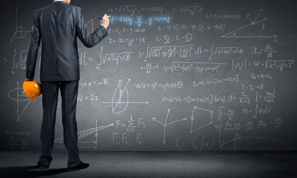 Man engineer drawing formulas — Stock Photo, Image