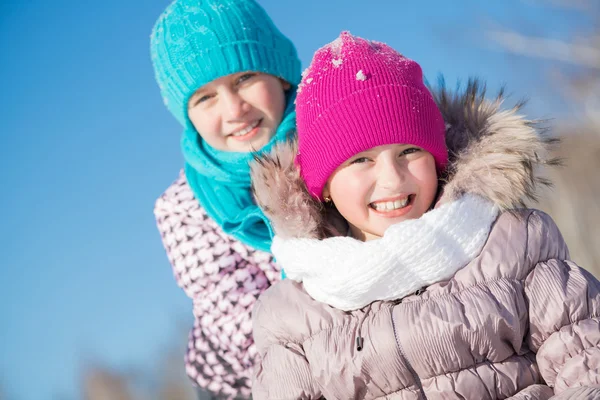 Cute girls riding sled — Stock Photo, Image