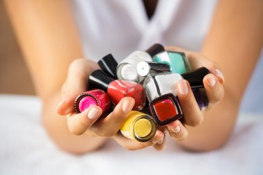 woman hands with nail polishes clipart