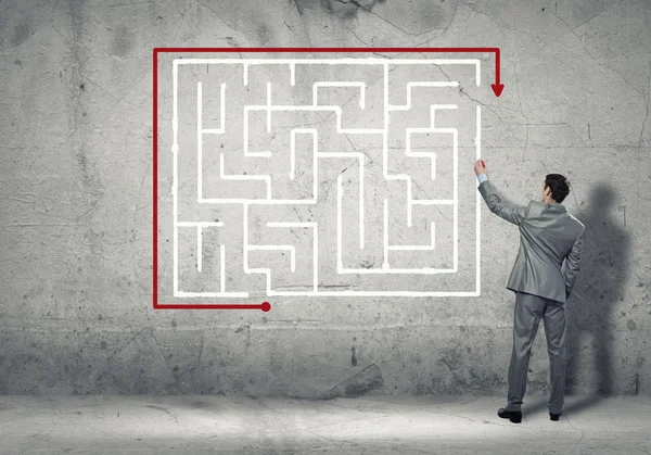 Businessman drawing labyrinth — Stock Photo, Image