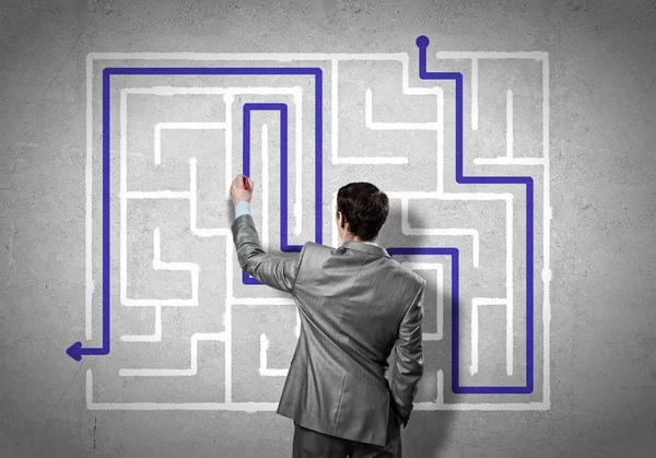 Businessman drawing labyrinth — Stock Photo, Image