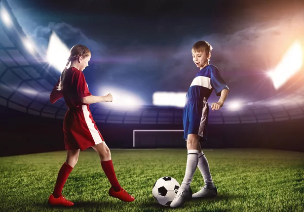 Teens playing football on stadium — Stock Photo, Image