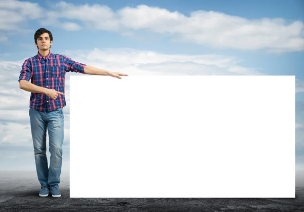 Handsome man with blank banner — Stock Photo, Image