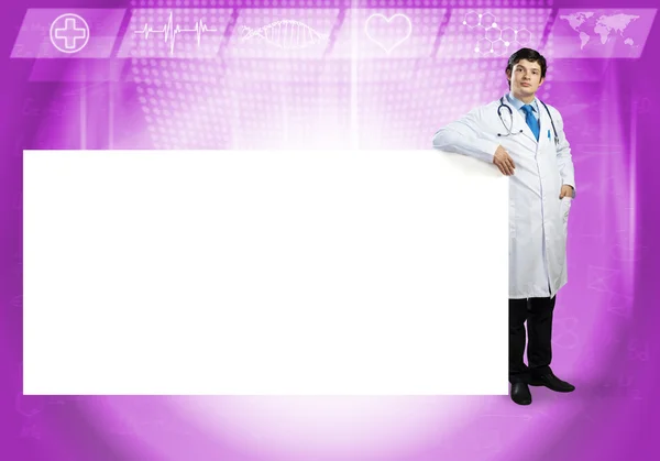 Handsome Doctor with blank banner — Stock Photo, Image