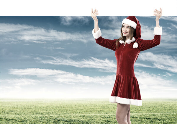 Attractive Santa woman with white blank banner