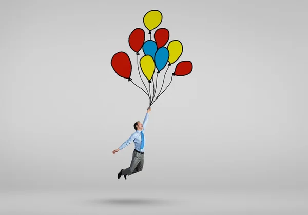 Businessman flying on balloons — Stock Photo, Image