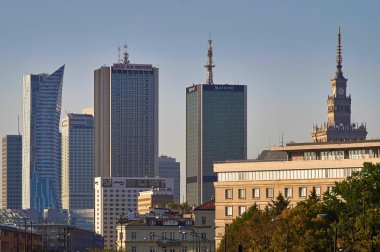 Warsaw, Poland - August 27, 2016: Panoramic view downtown on sunset, with Palace of Culture and Science, Polish: Palac Kultury i Nauki, also abbreviated PKiN. clipart