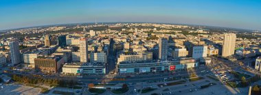 Warsaw, Poland - August 27, 2016: Aerial panoramic view to downtown of Polish Capital at sunset, from the top Palace Culture and Science: Palac Kultury i Nauki, also abbreviated PKiN. clipart