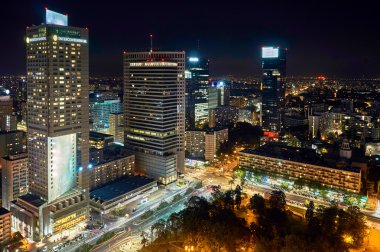 Warsaw, Poland - August 27, 2016: Aerial panoramic view to downtown of Polish Capital by night, from the top Palace Culture and Science: Palac Kultury i Nauki, also abbreviated PKiN. clipart