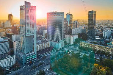 Warsaw, Poland - August 27, 2016: Aerial panoramic view to downtown of Polish Capital at sunset with lens flare, from the top Palace Culture and Science: Palac Kultury i Nauki, also abbreviated PKiN. clipart