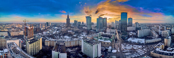 Beautiful panoramic aerial drone view on All Saints Church - Roman Catholic church located at Grzybowski Square, Warsaw City Skyscrapers, PKiN, and Varso Tower under construction. Warsaw, Poland.