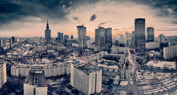 Beautiful panoramic aerial drone view on Warsaw City Skyscrapers, PKiN, and Varso Tower (the tallest skyscraper in the European Union) under construction during the January sunset. Warsaw, Poland.