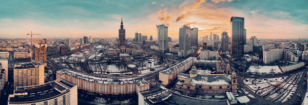 Beautiful panoramic aerial drone view on All Saints Church - Roman Catholic church located at Grzybowski Square, Warsaw City Skyscrapers, PKiN, and Varso Tower under construction. Warsaw, Poland.