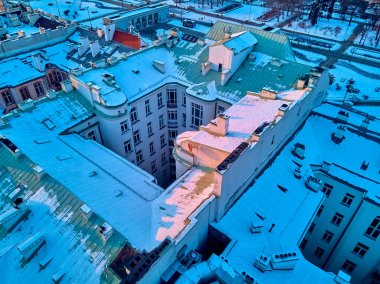 Beautiful panoramic aerial top-down drone view on snow-covered roofs of Warsaw 19th-century tenement houses during the January sunset, Warsaw, Poland. clipart