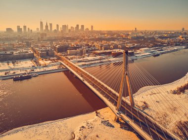 Beautiful panoramic winter aerial drone view to Warsaw city center with skyscrapers and Swietokrzyski Bridge (En: Holy Cross Bridge) - is a cable-stayed bridge over the Vistula river in Warsaw, Poland clipart