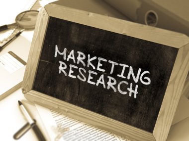 Hand Drawn Marketing Research Concept on Small Chalkboard.