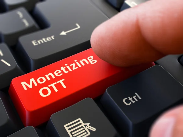 Finger Presses Red Keyboard Button Monetizing OTT. — Stockfoto