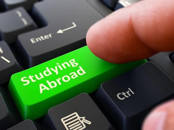 Estudiar en el extranjero - Hacer clic en el botón verde del teclado . — Foto de Stock