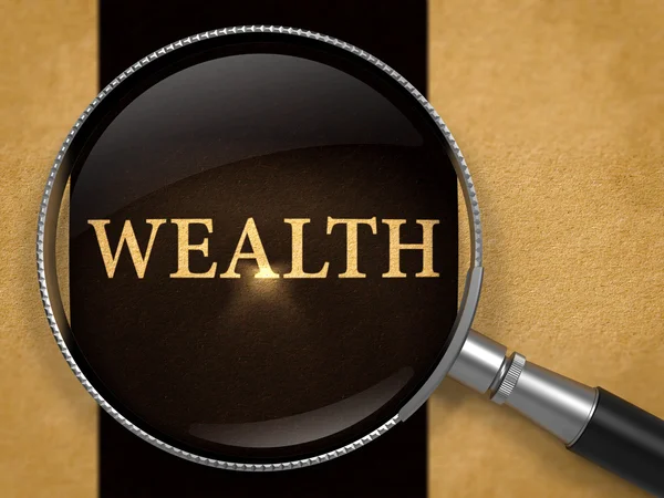 Wealth through Loupe on Old Paper. — Stock Photo, Image