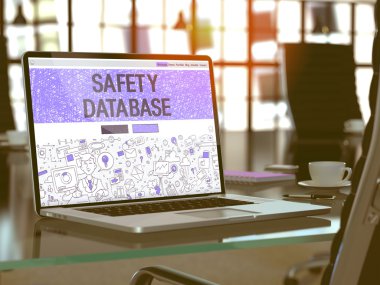 Safety Database on Laptop in Modern Workplace Background.