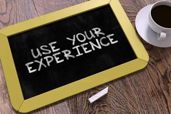 Handwritten Use Your Experience on a Chalkboard. — Stock Photo, Image