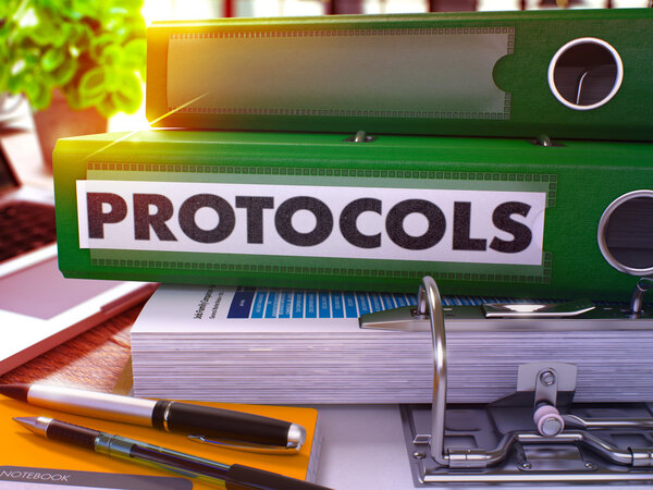 Protocols on Green Office Folder. Toned Image.