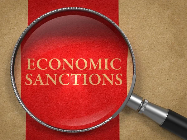 Sanções econômicas através de lupa . — Fotografia de Stock