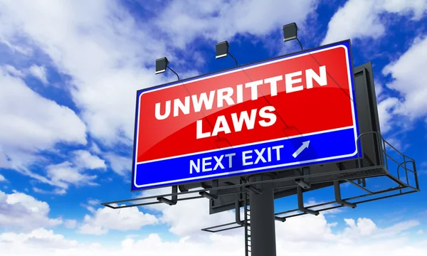 Unwritten Laws Inscription on Red Billboard. — Stock Photo, Image