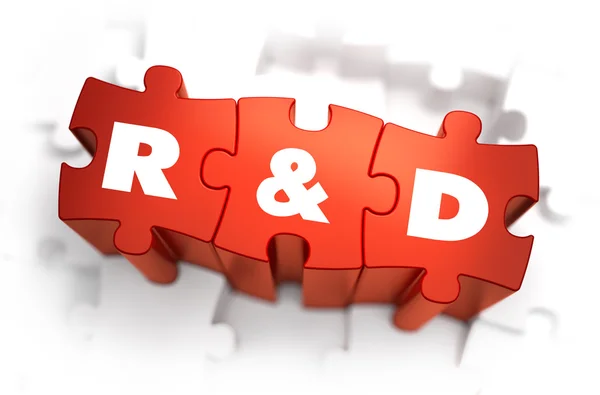 Дослідження та розробка - білий слово на червоний головоломки. — стокове фото