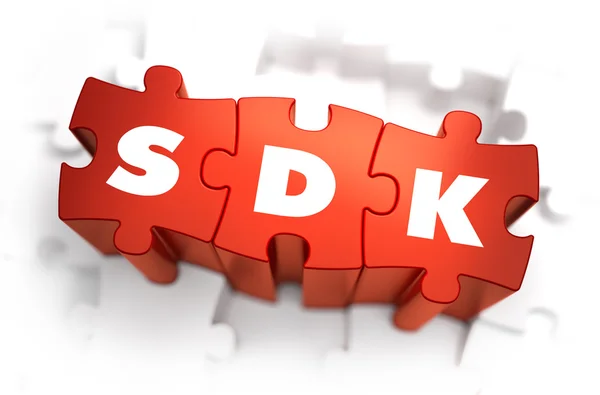 SDK - Text på röd pussel. — Stockfoto