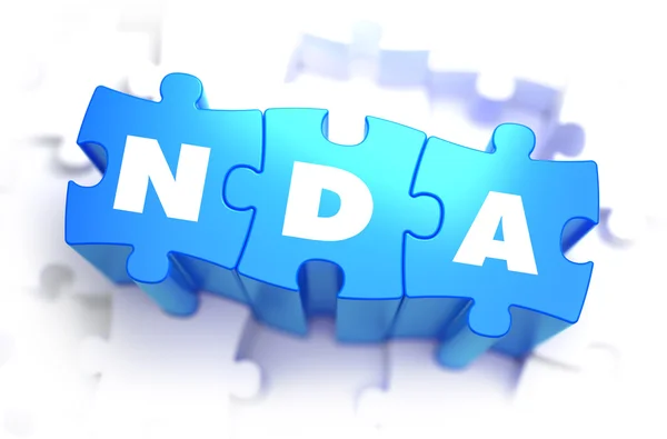 Nda - Text auf blauen Puzzles. — Stockfoto