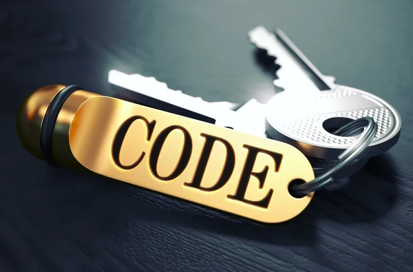 Código escrito no chaveiro dourado . — Fotografia de Stock
