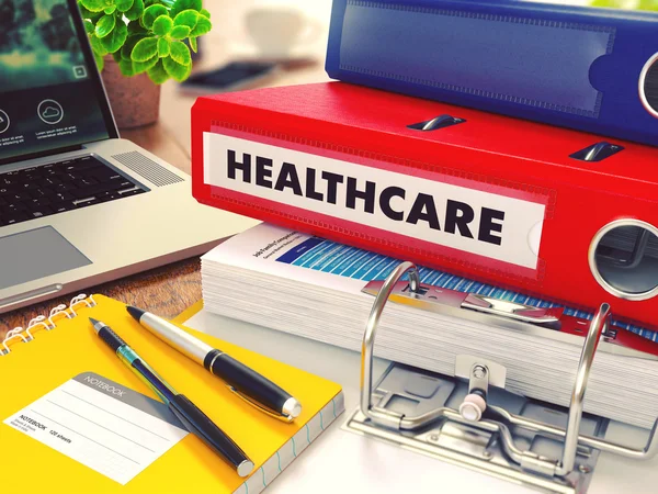 Healthcare on Red Office Folder. Toned Image. — Stock Fotó