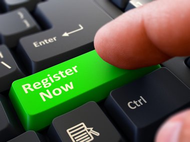 Pressing Green Button Register Now on Black Keyboard.