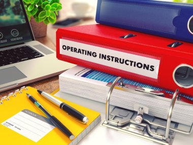 Operating Instructions on Red Office Folder. Toned Image.