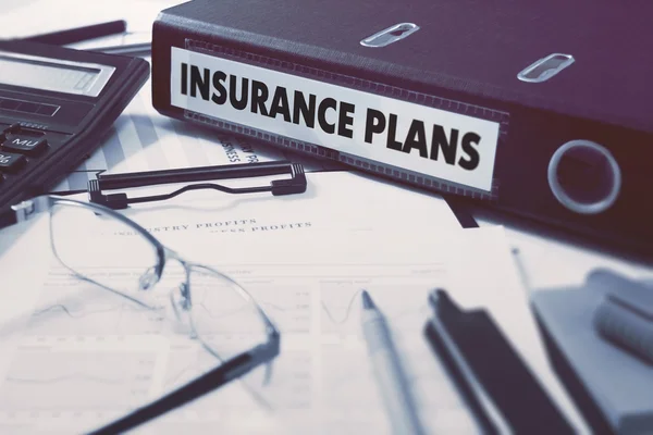 Insurance Plans on Ring Binder. Blured, Toned Image. Zdjęcie Stockowe