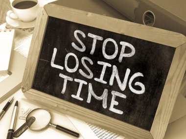 Stop Losing Time Handwritten on Chalkboard.