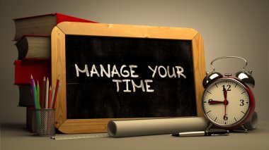 Handwritten Manage Your Time on a Chalkboard.