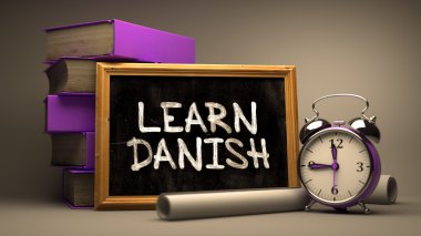 Hand Drawn Learn Danish Concept on Chalkboard.