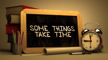 Some Things Take Time. Inspirational Quote on a Blackboard.