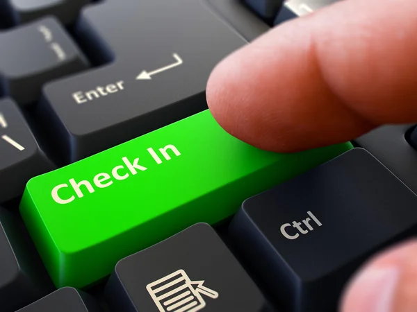 Finger Presses Green Keyboard Button Check In. — Stock Photo, Image
