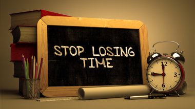 Handwritten Stop Losing Time on a Chalkboard.