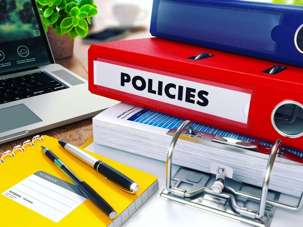 Policies on Red Ring Binder. Blurred, Toned Image.