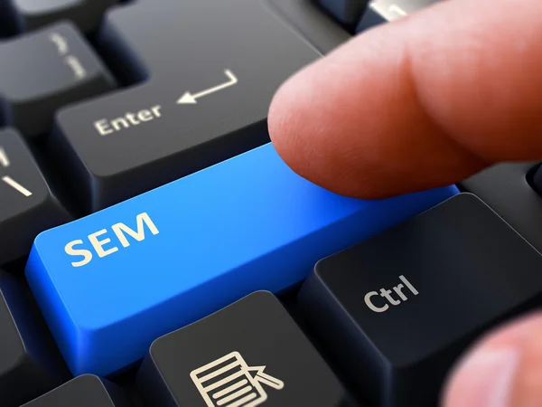 Finger Presses Blue Keyboard Button SEM. — Stock Photo, Image