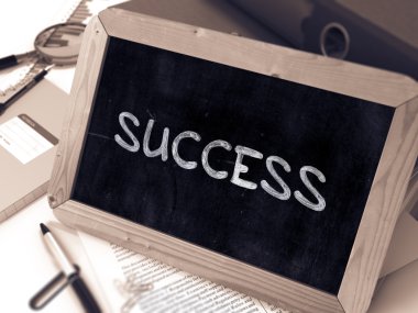 Success Handwritten by White Chalk on a Blackboard.