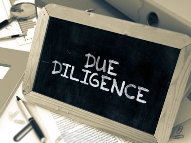 Due Diligence Handwritten on Chalkboard.