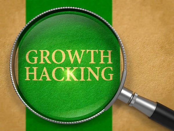 Growth Hacking through Loupe on Old Paper. — Stock Photo, Image